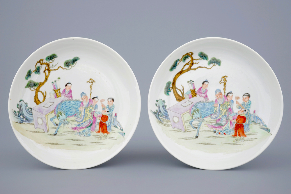 Two Chinese famille rose plates with figures and a dragon in a garden, 19/20th C.