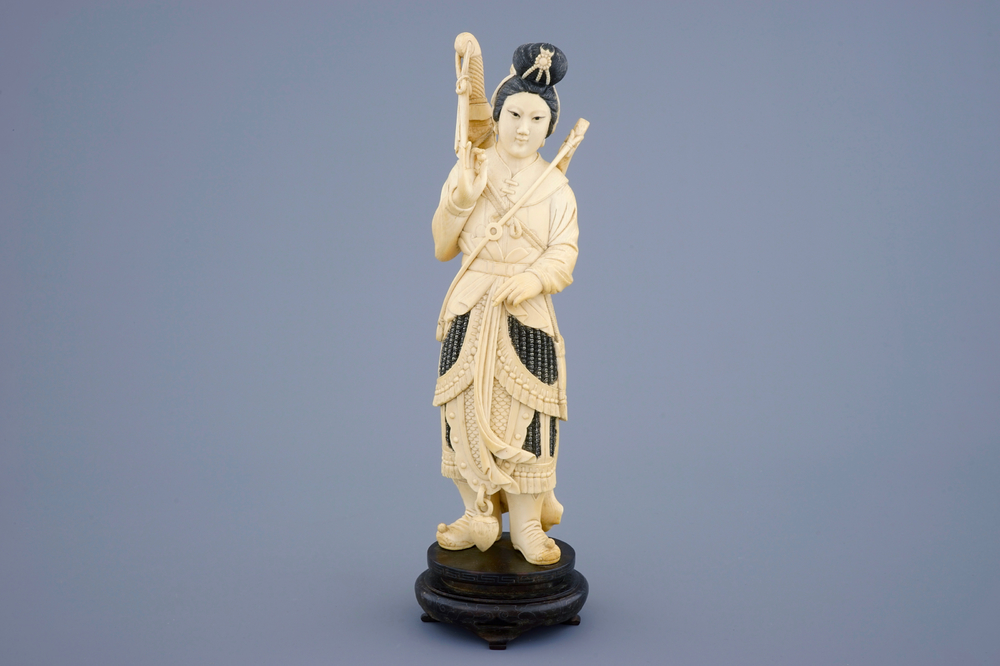 A Chinese carved ivory figure of a female warrior on a wooden base, late 19th C.