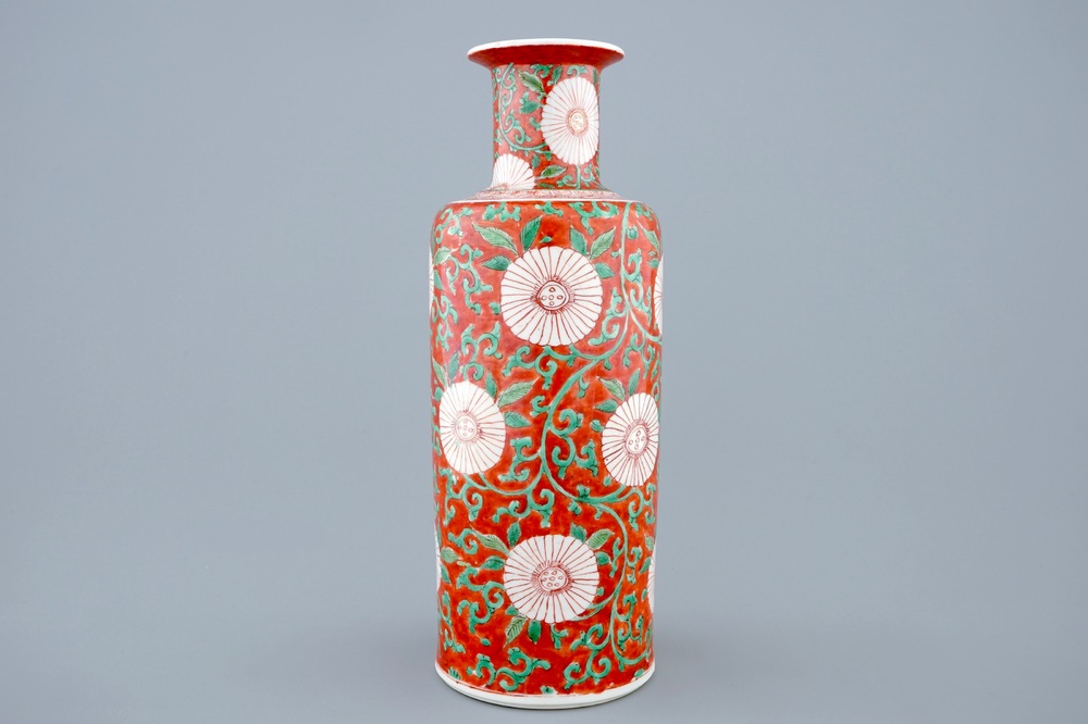 A Chinese famille verte coral-ground rouleau vase with peony scrolls, Kangxi
