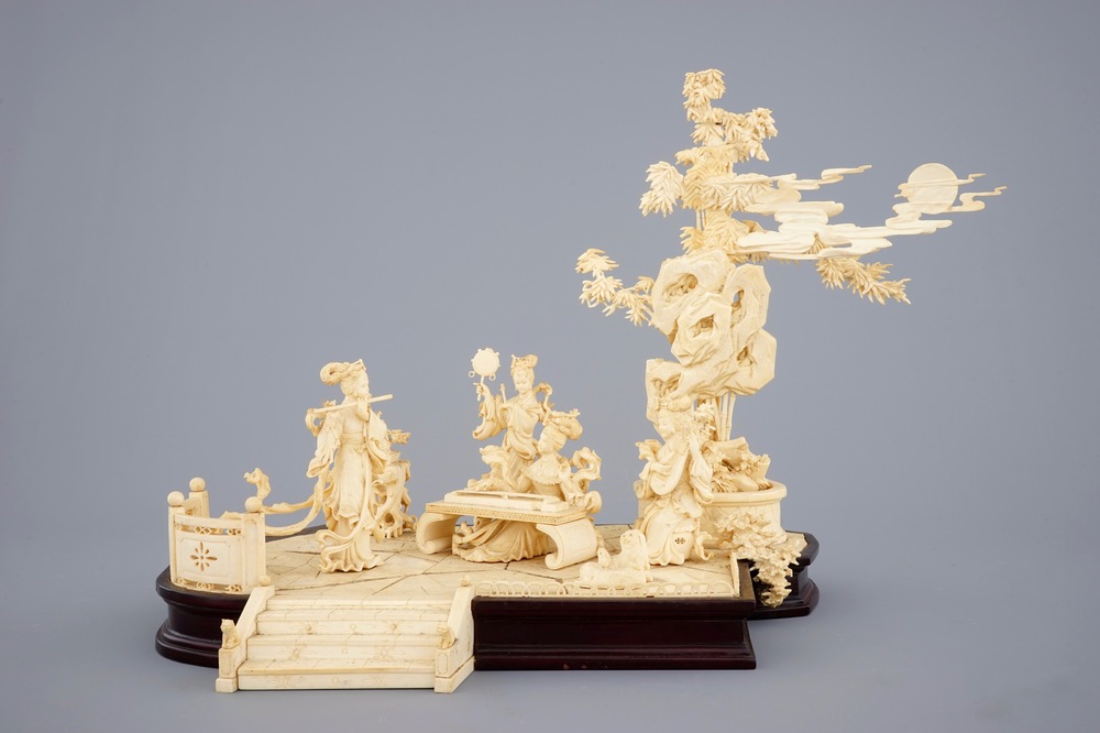 A large Chinese carved ivory group of musicians on a wooden base, early 20th C.