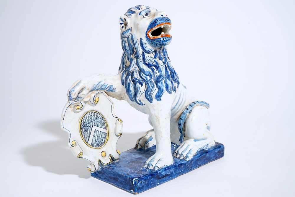 A large Dutch Delft figure of a lion with a coat of arms, 19th C.