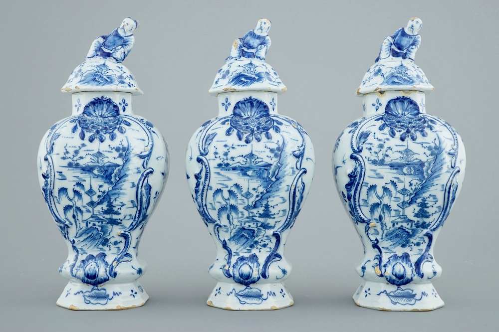 A Dutch Delft blue and white three-piece garniture with chinoiserie landscapes, 18th C.