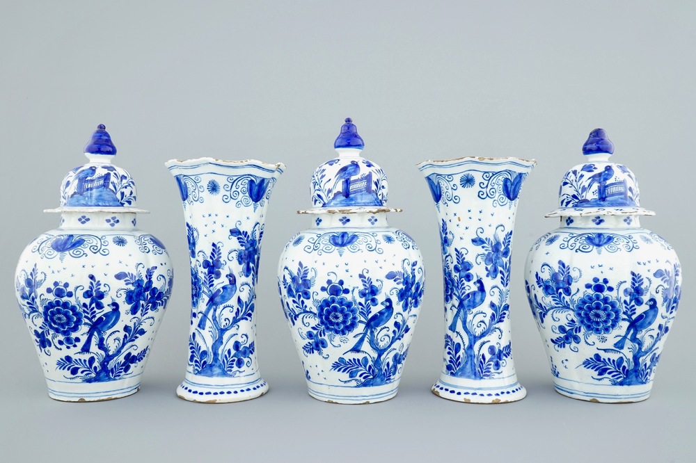 A tall blue and white Dutch Delft five-piece garniture with parrots among foliage, 18th C.