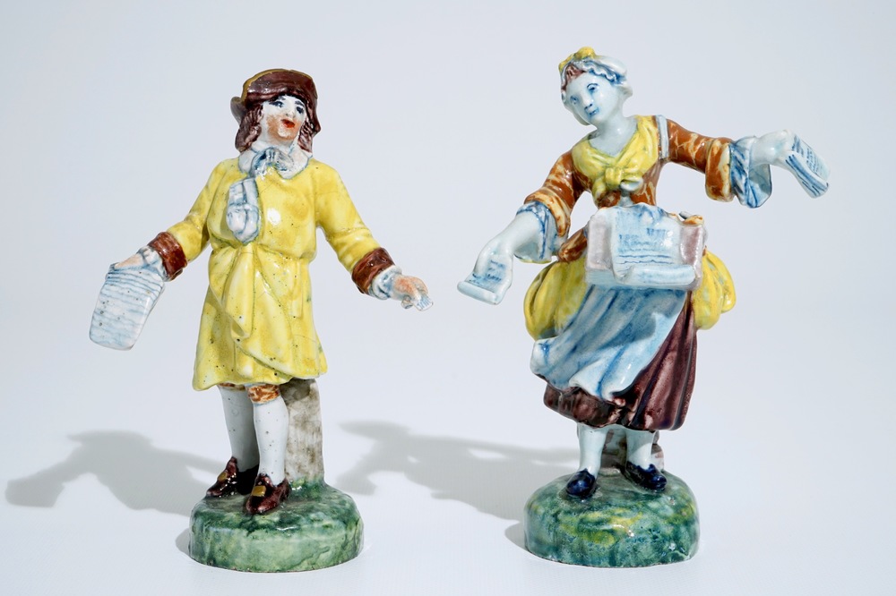 A pair of polychrome figures of newspaper sellers in Dutch Delft style, North of France, 19th C.