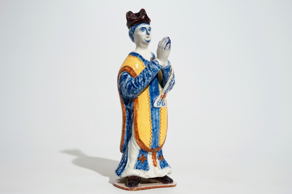 A large Dutch Delft polychrome figure of a standing priest, 18th C.