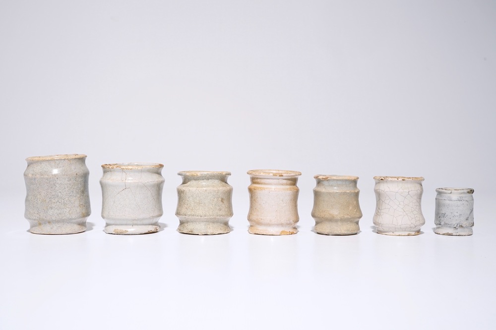 A set of seven white Dutch Delft albarello-shaped ointment jars, 17th C.