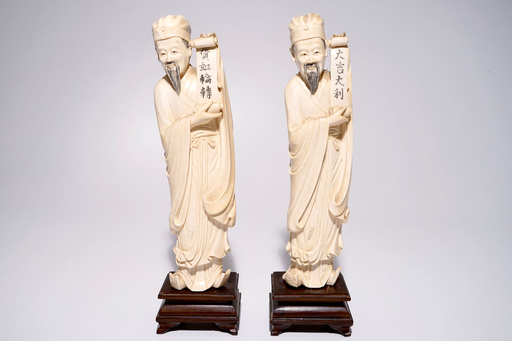 A pair of large Chinese ivory carvings of sages with scrolls, 19th C.