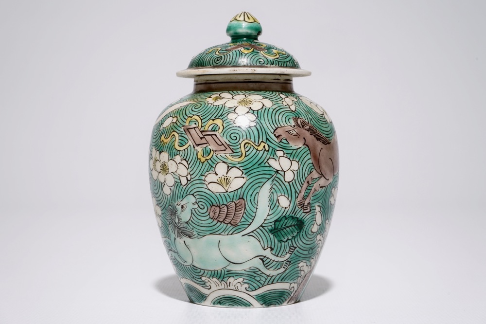 A Chinese verte biscuit covered jar with horses, Kangxi