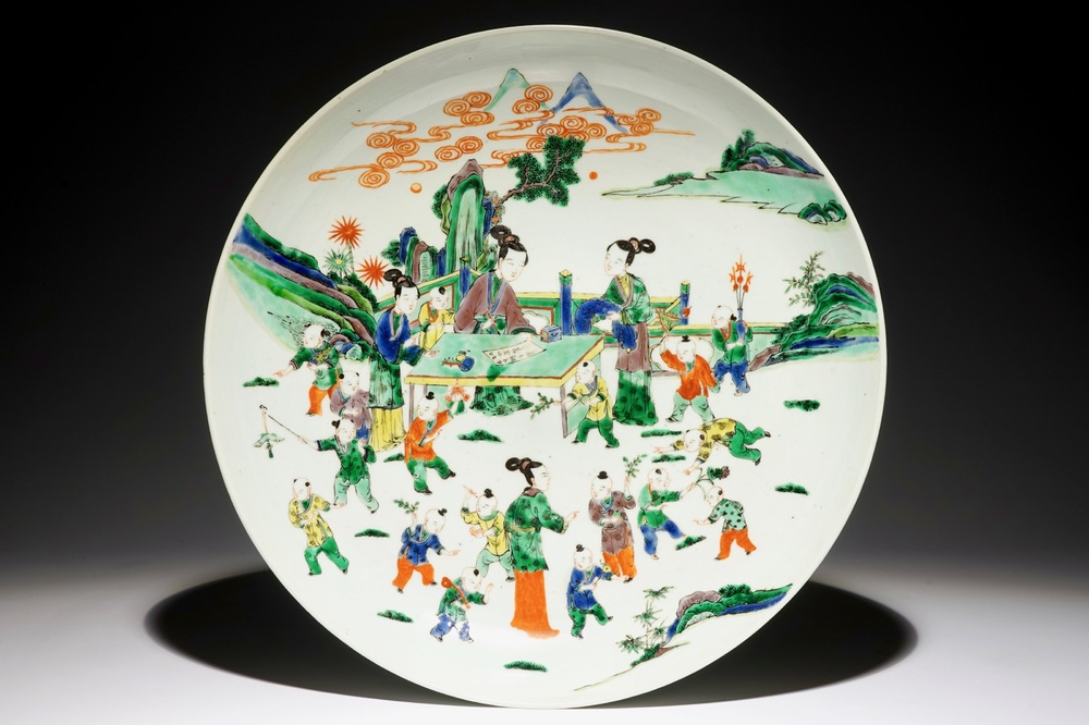 A very large Chinese famille verte dish with ladies and playing boys in a garden, 19th C.