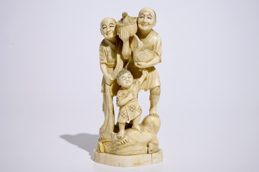 A Japanese ivory okimono of bird catchers, Meiji, early 20th C., signed