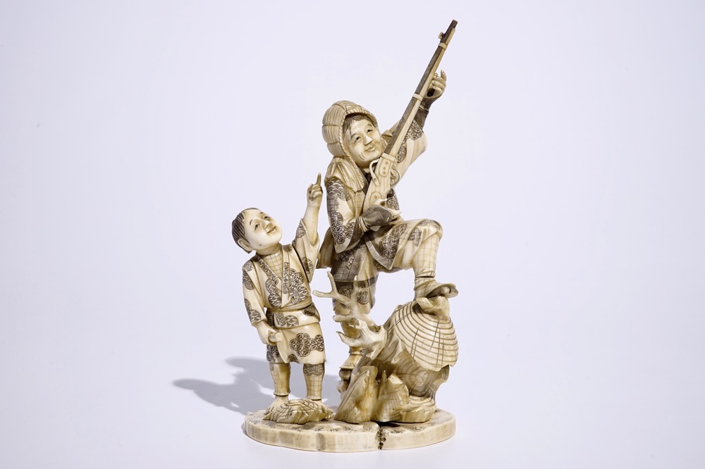 A Japanese ivory okimono of a hunter and his son, Meiji, late 19th C., signed