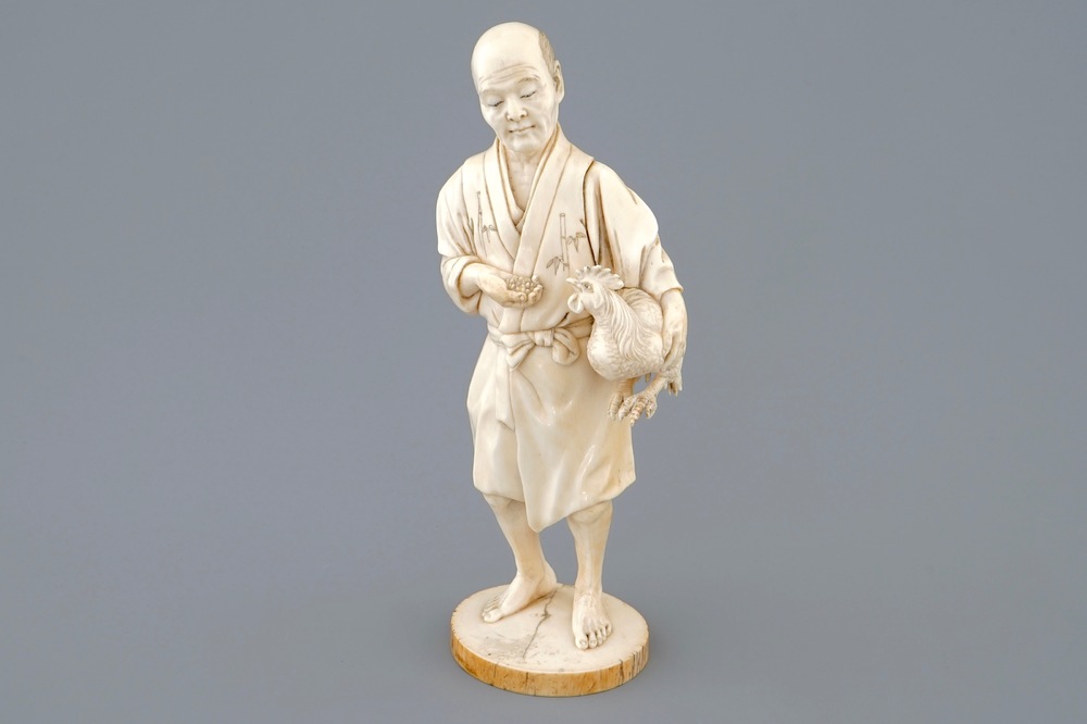 A Japanese ivory okimono of a chicken farmer, Meiji, 19th C., signed