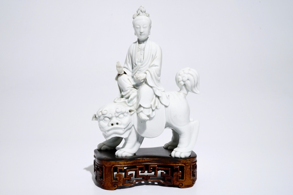 A Chinese Dehua blanc de Chine model of Guanyin seated on a Buddhist lion, 19th C.