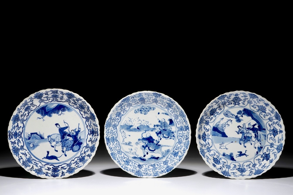 Three Chinese blue and white fluted plates with a Mongolian hunting scene, Chenghua marks, Kangxi