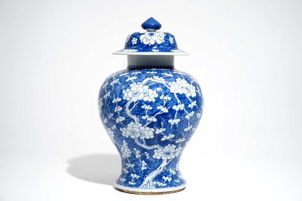 A Chinese blue and white baluster vase and cover with prunus on cracked ice, Kangxi