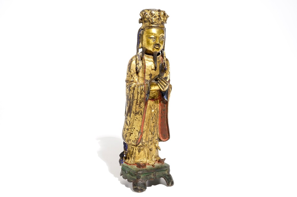 Een Chinese deels vergulde en polychrome bronzen figuur van Wenchang Dijun, Ming