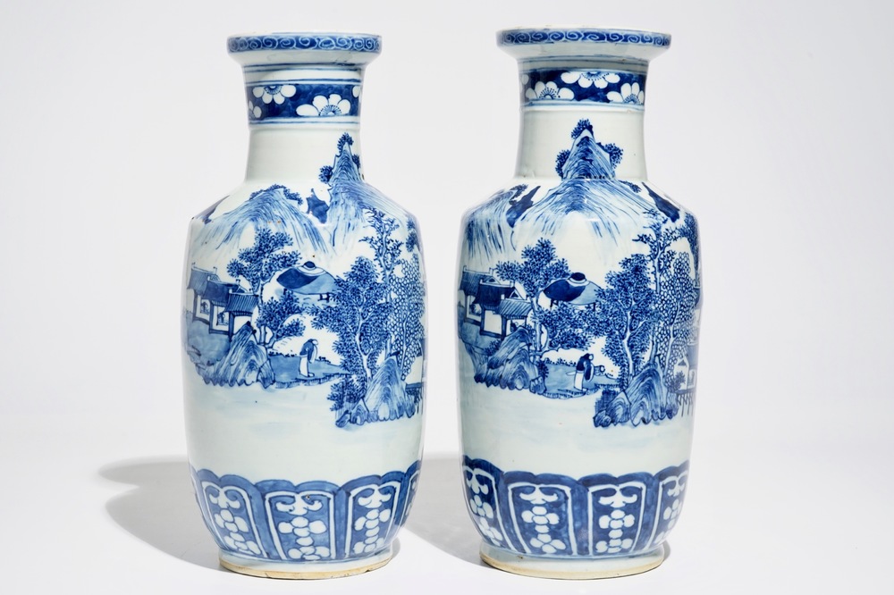 A pair of Chinese blue and white rouleau vases with landscape design, 19th C.