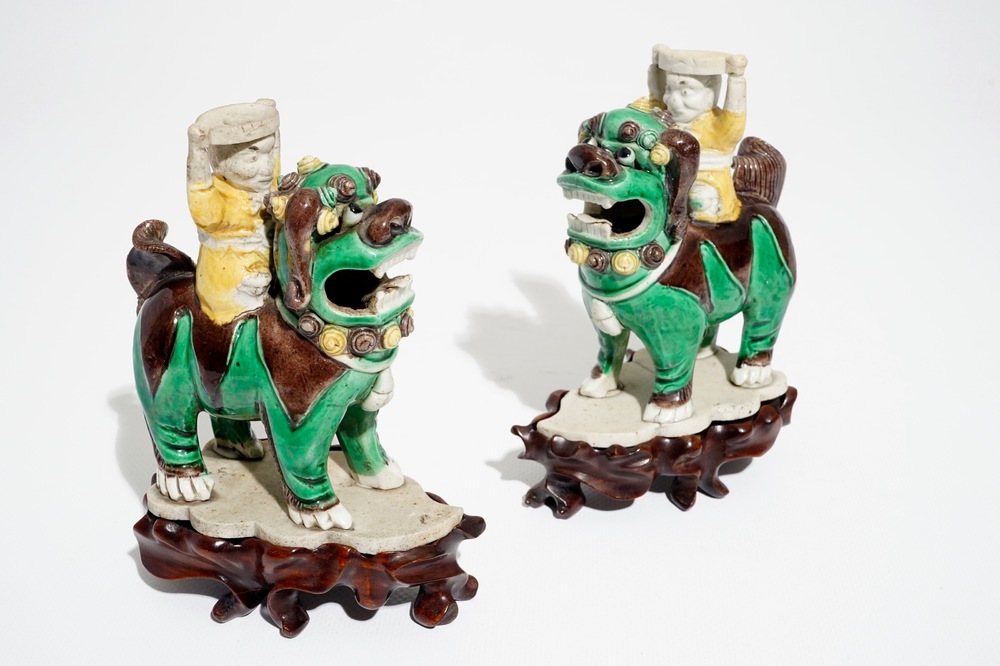 A pair of Chinese verte biscuit joss stick holders shaped as warriors on Buddhist lions, Kangxi