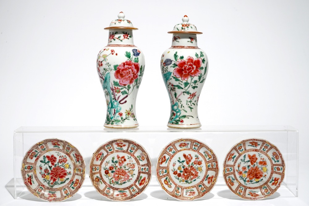 A pair of Chinese famille rose covered vases and four saucers, Yongzheng/Qianlong