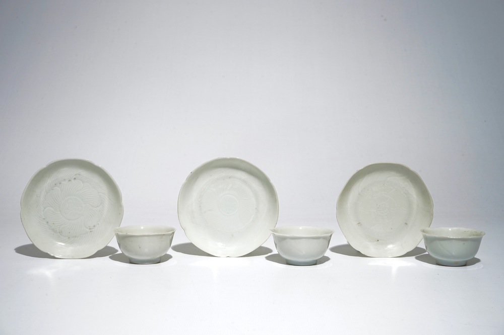 Three blanc de Chine cups and saucers with floral anhua design, Yongzheng/Qianlong