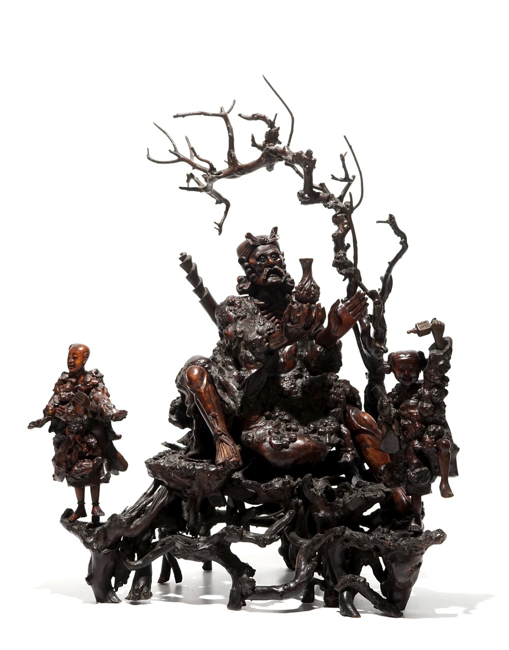 A large Chinese carved root wood group with a Luohan, 19th C.