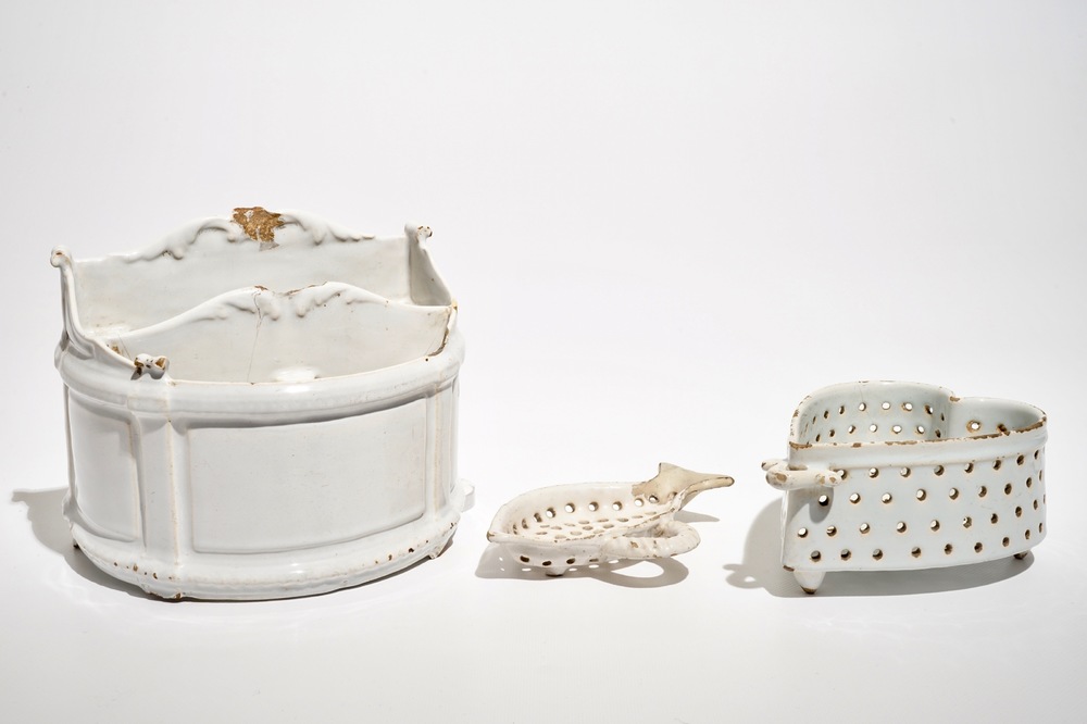 A white Dutch Delft letter holder and two strainers, 18th C.