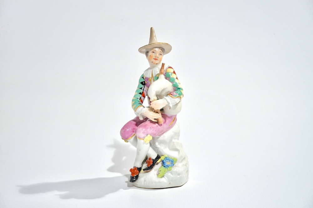 A Meissen porcelain Commedia del'Arte figure of Harlequin playing the bagpipe, 18th C.