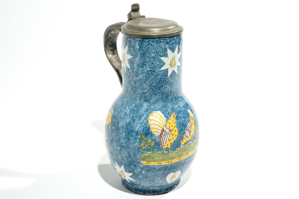 A large blue ground Brussels faience jug with a hen and a cockerel, 18/19th C.