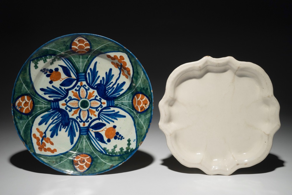 A polychrome Dutch Delft &quot;Four-hearts&quot; plate and a quatrefoil white Delft plate, 18th C.