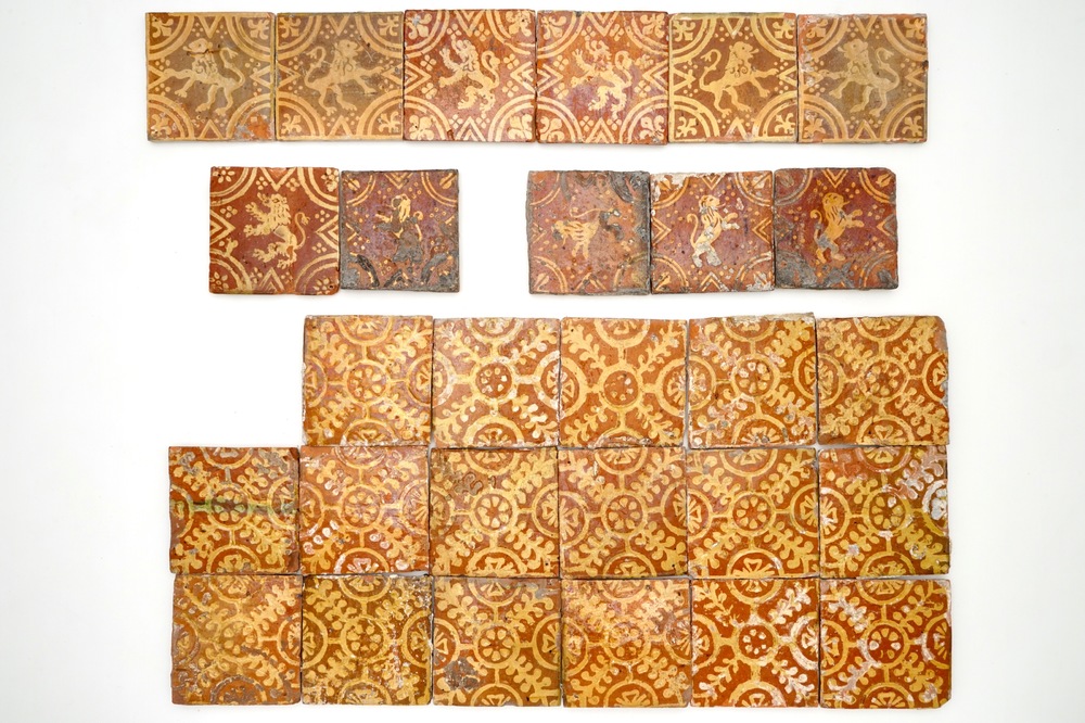 A group of 28 slip-decorated Flemish medieval style tiles with rampant lions and ornamental designs, 18th C.