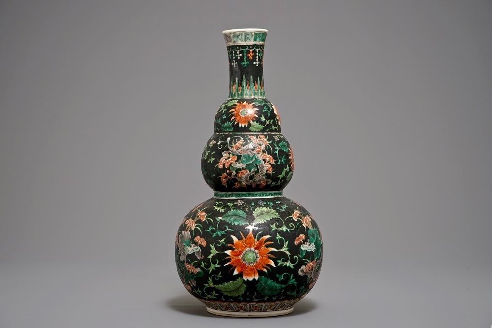 A Chinese black-ground famille verte double gourd dragon vase, 19th C.