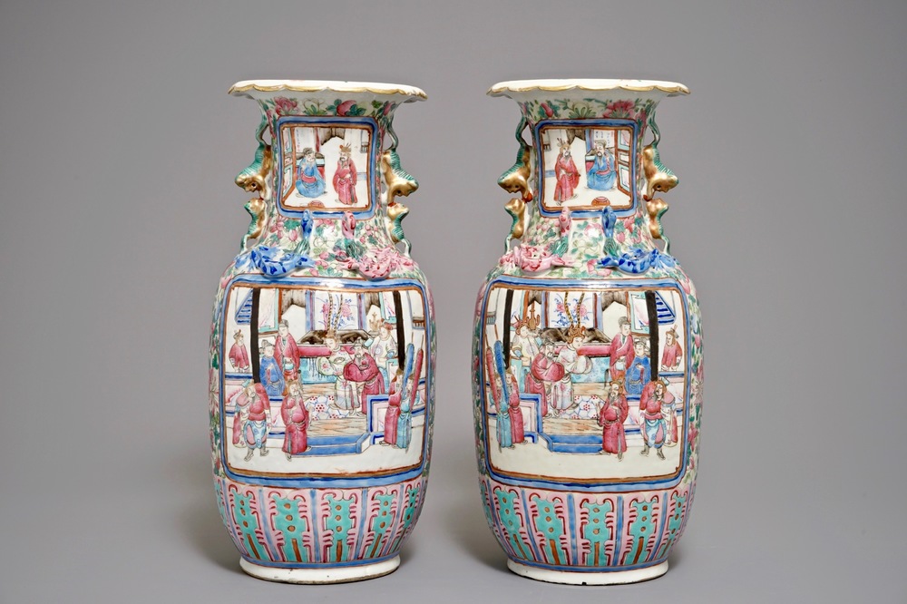 A pair of Chinese famille rose vases with figures in an interior, 19th C.