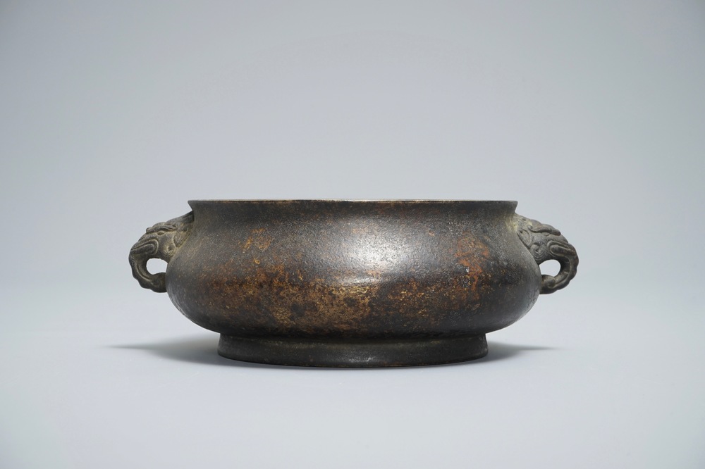 A Chinese bronze incense burner with elephant head handles, qianqing gongbao mark, Ming