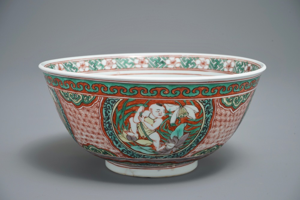 A Chinese wucai bowl with boys holding lotus flowers, Transitional period