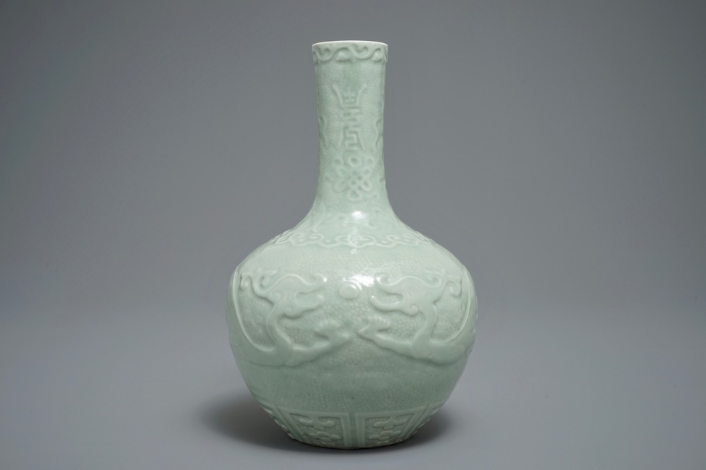 A Chinese bottle-shaped celadon vase with applied design, Qianlong mark, 19/20th C.