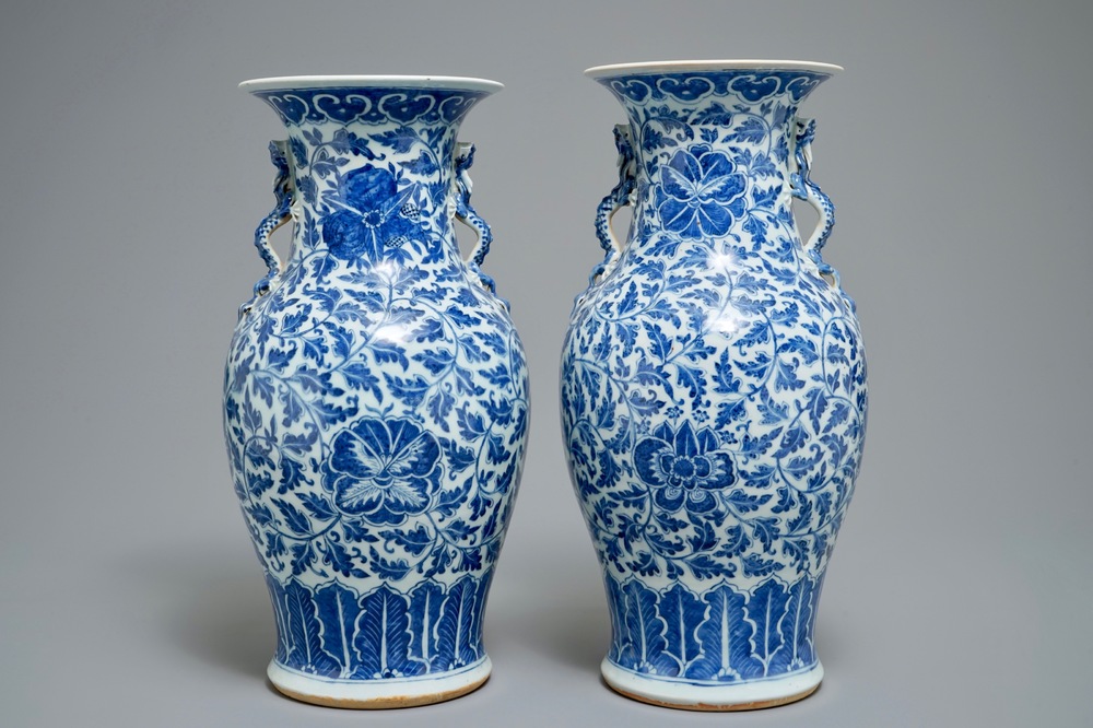 A pair of Chinese blue and white flower scroll vases, 19th C.