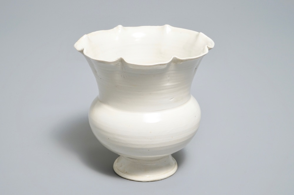 A Chinese foliate-rimmed cream-glazed dingyao bowl on foot, Song or later