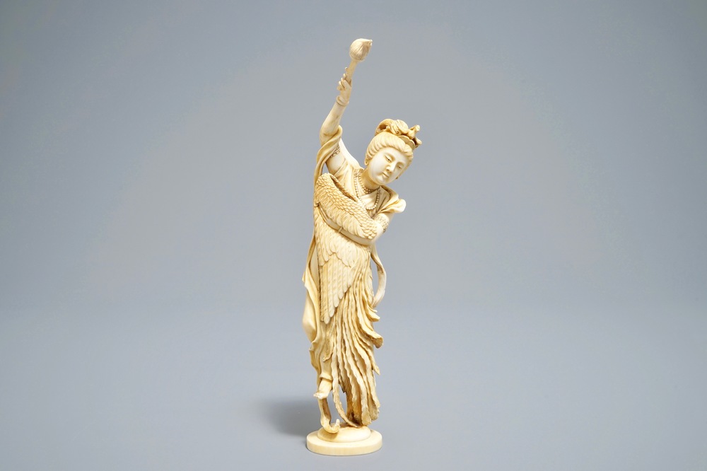 A Japanese ivory okimono of the goddess Kannon holding a fenghuang wing, signed, Meiji, 19th C.