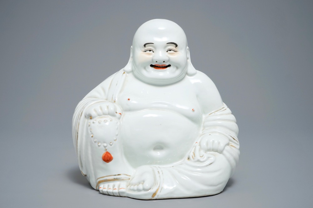 A large Chinese white, iron red and gilt porcelain figure of Buddha, 19/20th C.