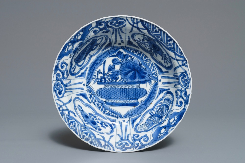 A Chinese blue and white kraak porcelain klapmuts bowl with a flower basket, Wanli