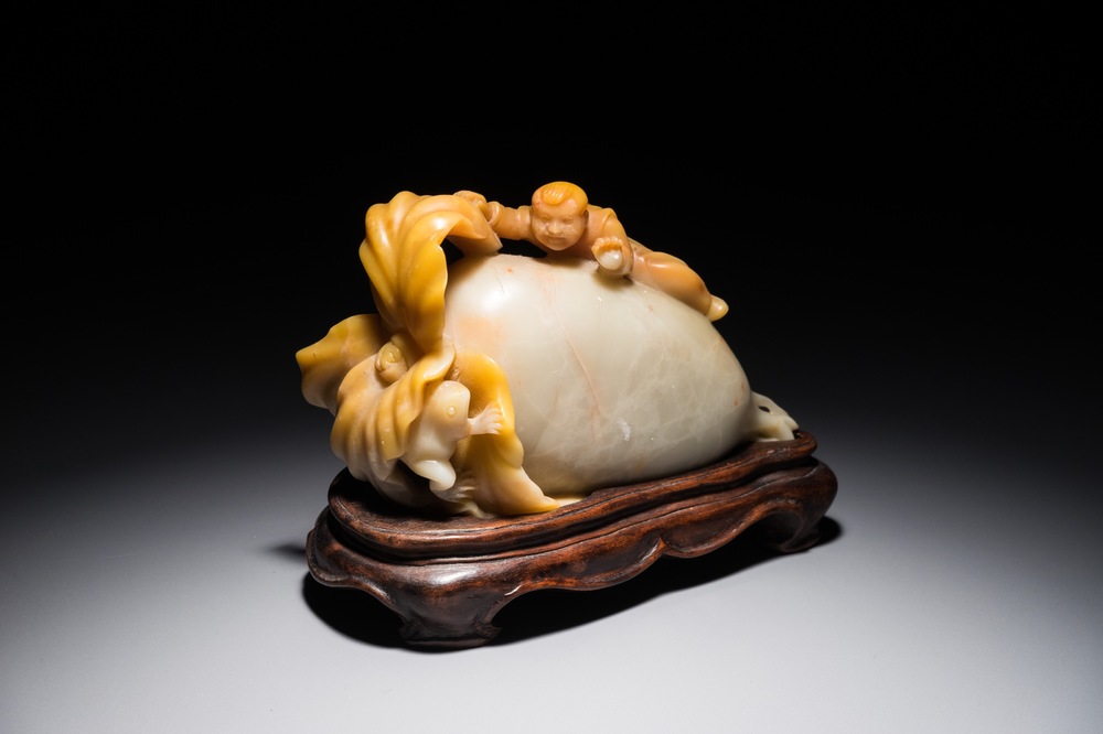 A Chinese jade group of a raphanus with a playing boy and frog, 19/20th C.