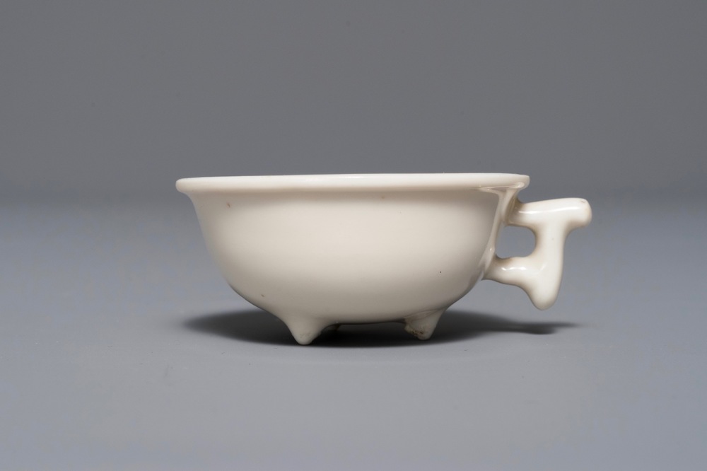 A Chinese Dehua blanc de Chine tripod cup, Kangxi