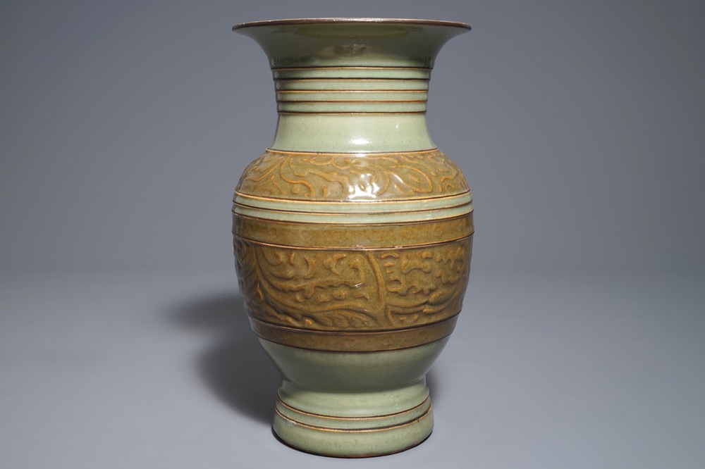 A Chinese archaistic celadon-glazed vase with moulded design, 19th C.