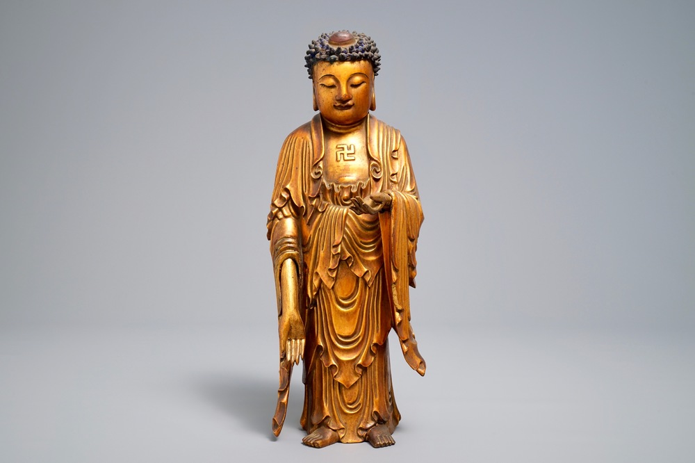 A Chinese carved gilt wood figure of Buddha standing, 18/19th C.