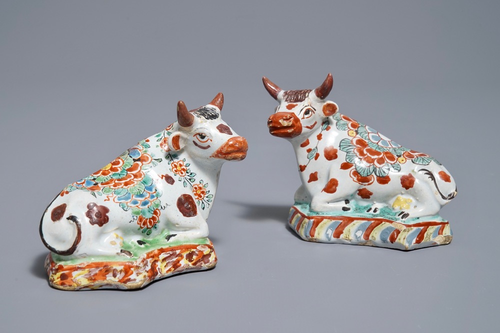 A pair of polychrome Dutch Delft petit feu cows on bases, 18th C.