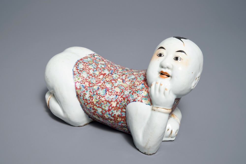 A Chinese famille rose headrest in the shape of a boy, Republic, early 20th C.