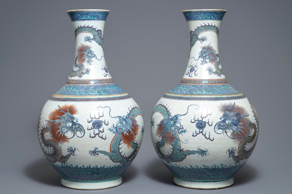 A pair of large Chinese doucai 'dragon' bottle vases, tianqiu ping, Qianlong mark, 19th C.