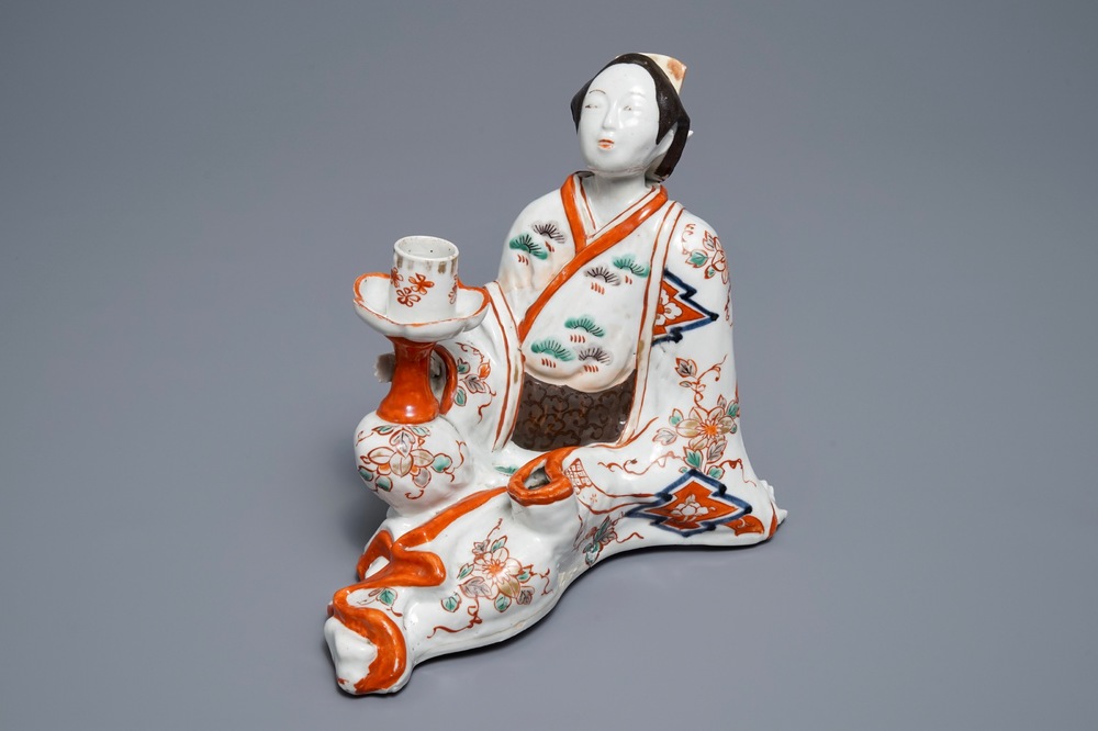 A Japanese Imari figure of a Bijin with candle holder, Edo, 17/18th C.