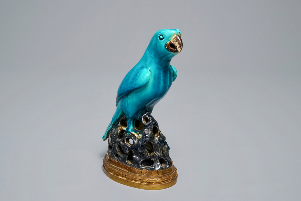 A Chinese turquoise-glazed parrot mounted on gilt bronze stand, Kangxi