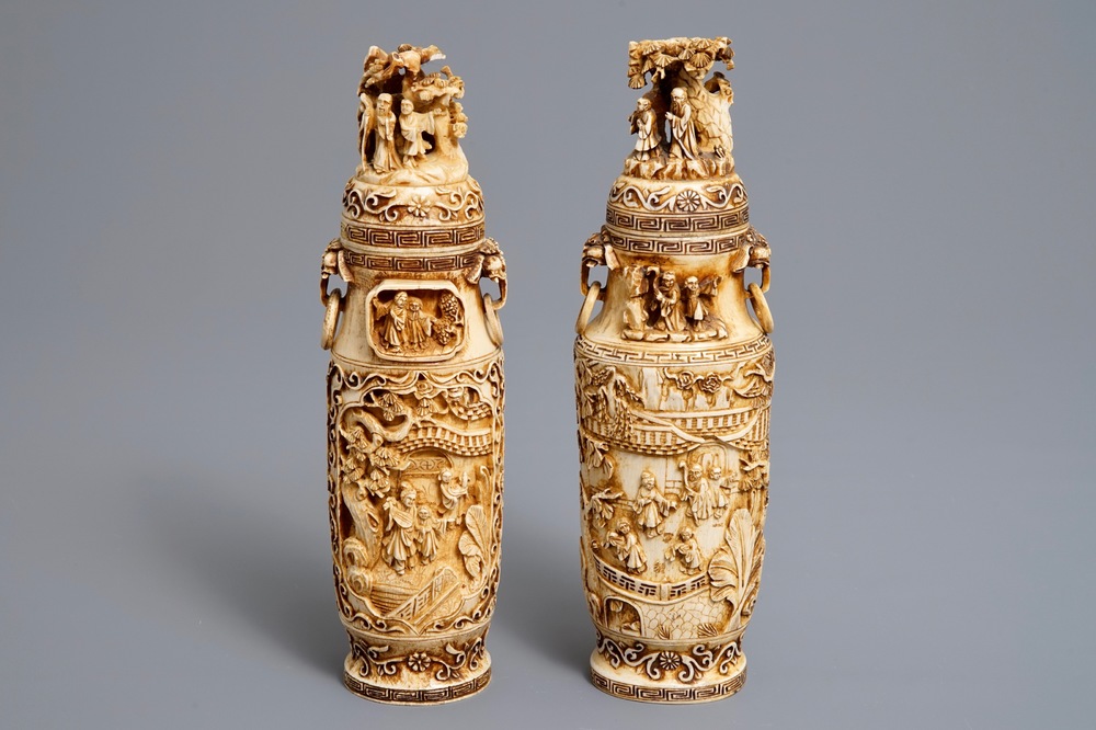 A pair of Chinese ivory vases and covers with figures in landscapes, 1st quarter 20th C.